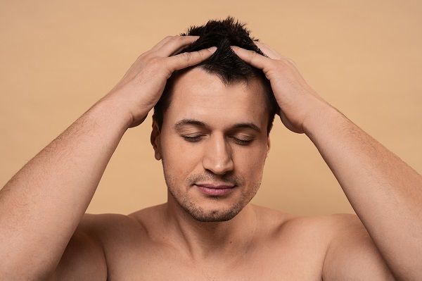 Man giving himself scalp massage