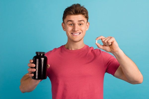 Man with protein bottle in hand