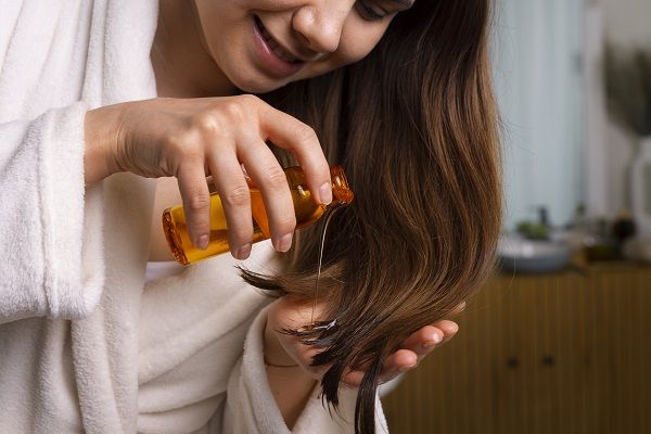 Woman applying keratin treatment to her hair