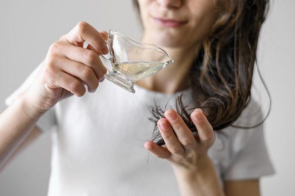 Young woman applying untangle product